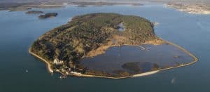 An aerial shot on a sunny day, showing Brownsea Island, Dorset, surrounded by sea