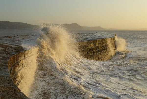 Big waves splashing on the Cobb in Lyme Regis, Dorset
