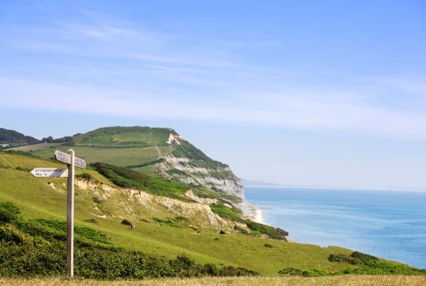 A signpost on the Jurassic Coast, Dorset, UK. Golden cap in the background.