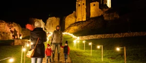 A family walk through Christmas lights at Corfe Castle, Dorset