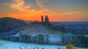 Corfe Castle in the Snow at Sunset