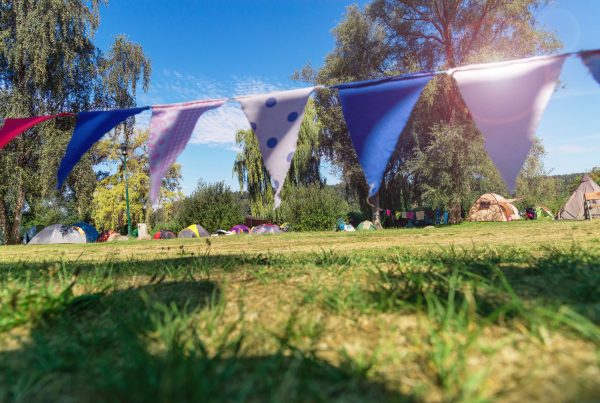 Sunny campsite with red, white and blue bunting.
